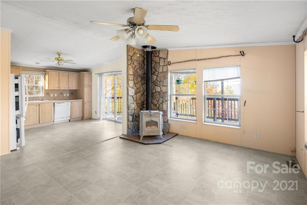 2226 Poplar Cove Road Clyde, NC 28721 - Photo 10 of 21 a view of a livingroom with furniture ceiling fan and window