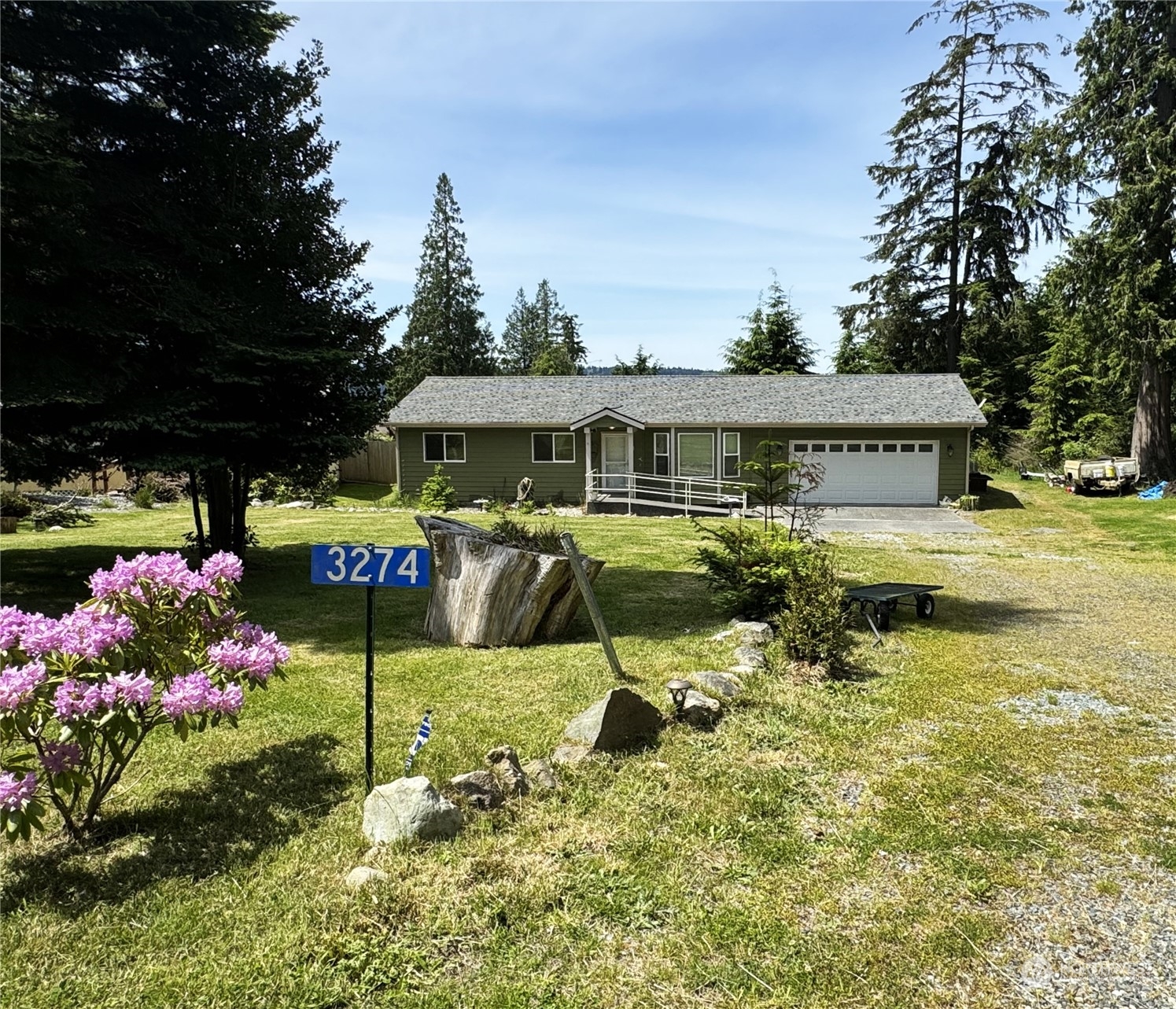 3274 East Harbor Road Langley, WA 98260 - Photo 1 of 21 a front view of a house with garden