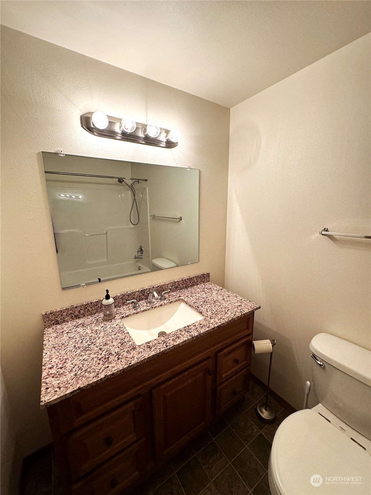 3274 East Harbor Road Langley, WA 98260 - Photo 11 of 21 a bathroom with a granite countertop sink a toilet and a mirror