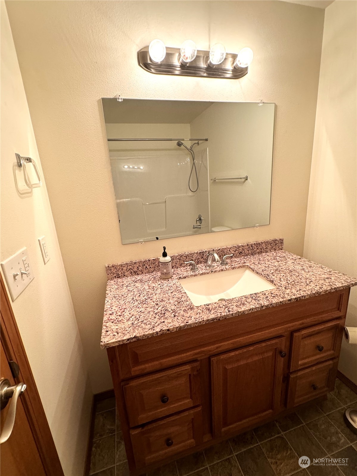 3274 East Harbor Road Langley, WA 98260 - Photo 12 of 21 a bathroom with a granite countertop sink and a mirror