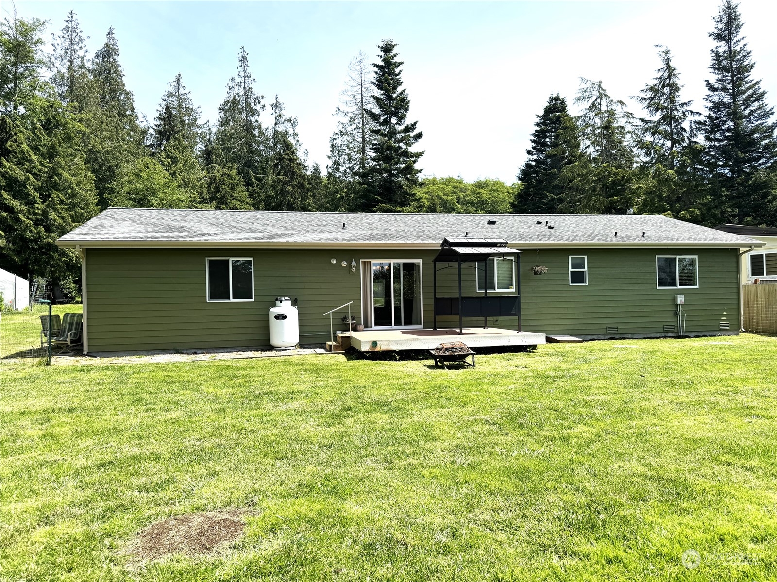 3274 East Harbor Road Langley, WA 98260 - Photo 2 of 21 a view of a house with a swimming pool and a yard