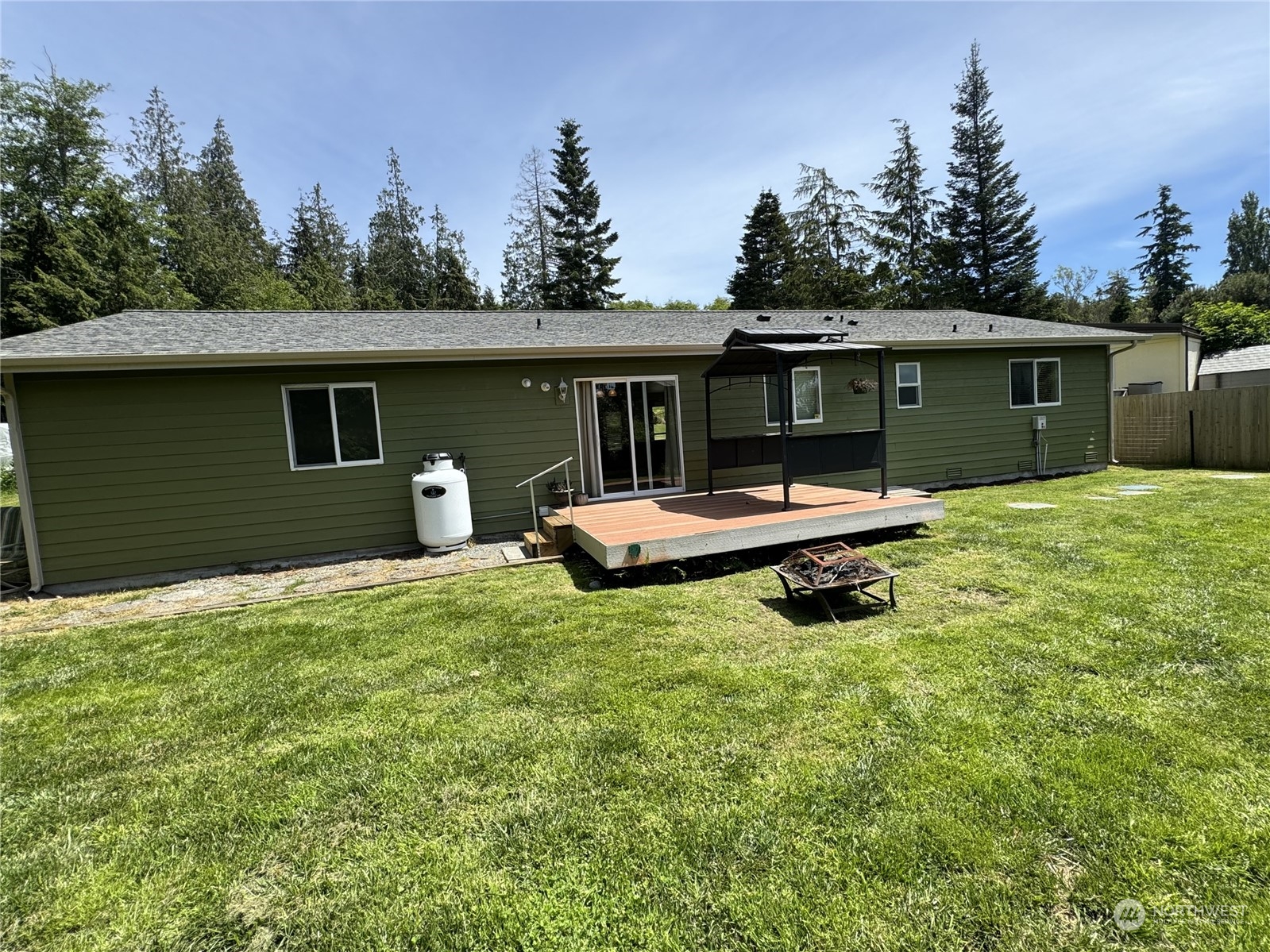 3274 East Harbor Road Langley, WA 98260 - Photo 21 of 21 a backyard of a house with yard table and chairs