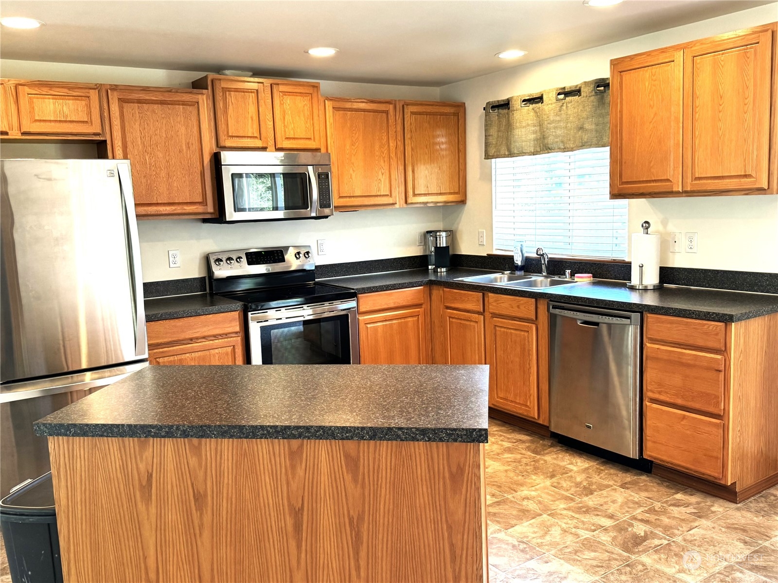 3274 East Harbor Road Langley, WA 98260 - Photo 7 of 21 a kitchen with stainless steel appliances granite countertop a stove a sink dishwasher and a refrigerator