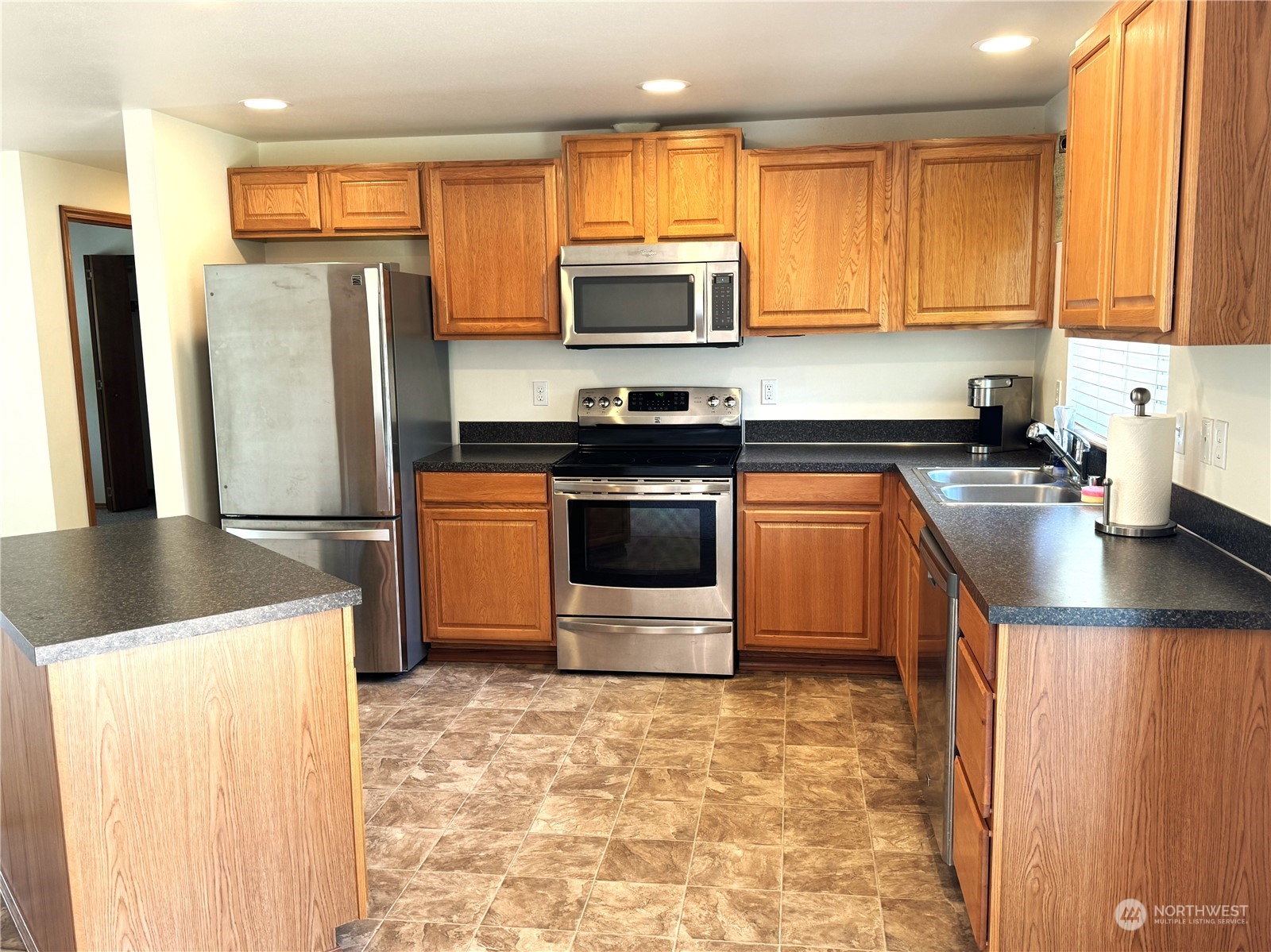 3274 East Harbor Road Langley, WA 98260 - Photo 8 of 21 a kitchen with stainless steel appliances granite countertop a stove a refrigerator and a microwave