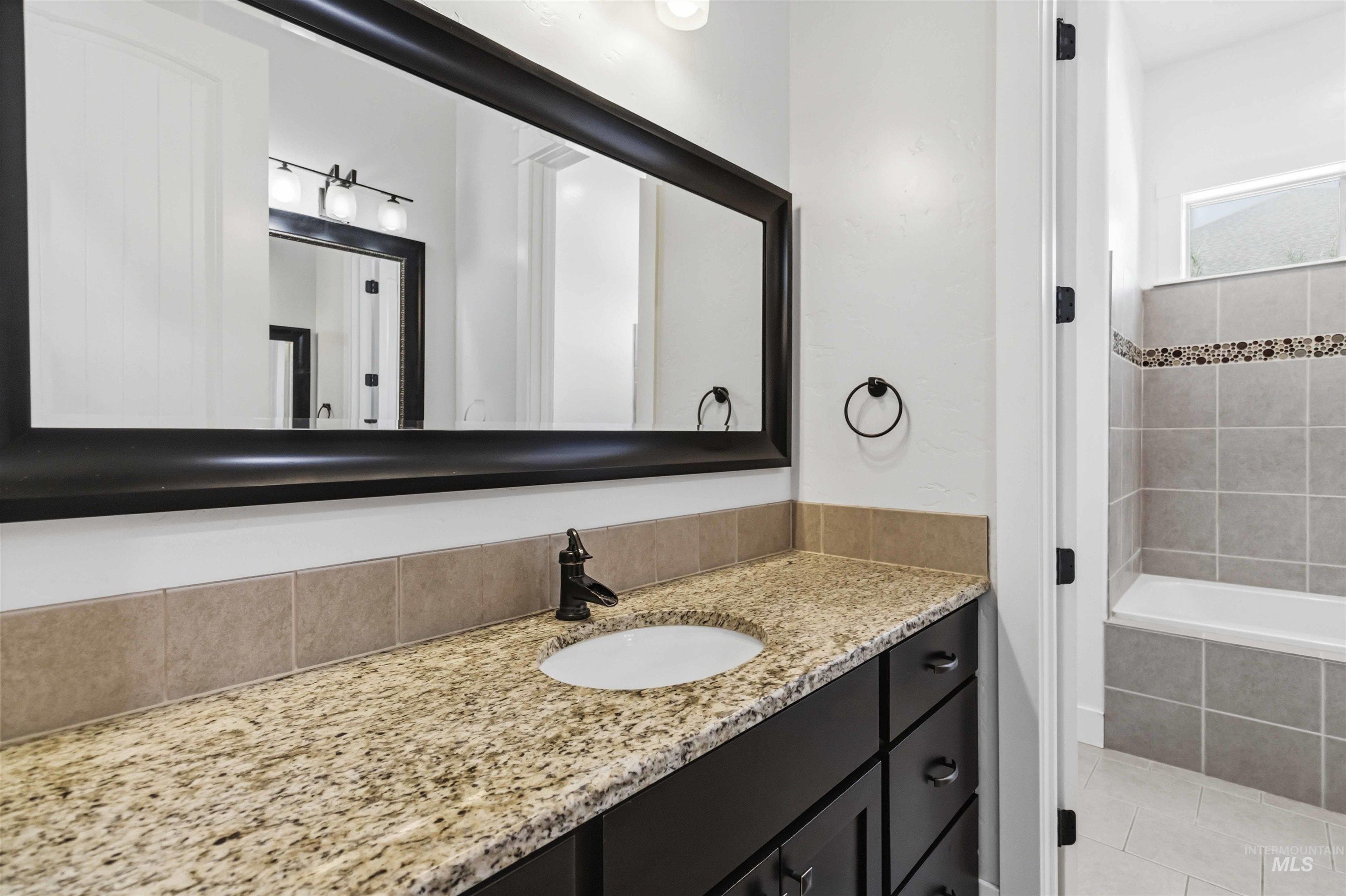 3218 North Cherry Laurel Way Star, ID 83669 - Photo 34 of 50 Interior space featuring neutral wall paint, white wainscoting, and gray carpeting