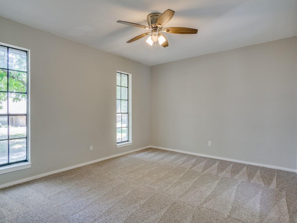 9523 Bellechase Road Granbury, TX 76049 - Photo 22 of 25 an empty room with windows and chandelier fan