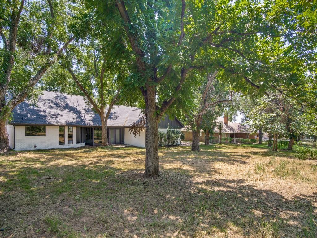 9523 Bellechase Road Granbury, TX 76049 - Photo 24 of 25 a house with trees in front of it
