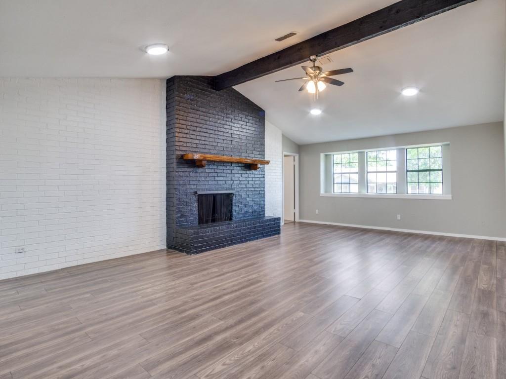 9523 Bellechase Road Granbury, TX 76049 - Photo 3 of 25 an empty room with wooden floor fireplace and windows