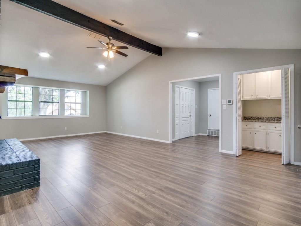 9523 Bellechase Road Granbury, TX 76049 - Photo 4 of 25 a view of an empty room with a window and wooden floor