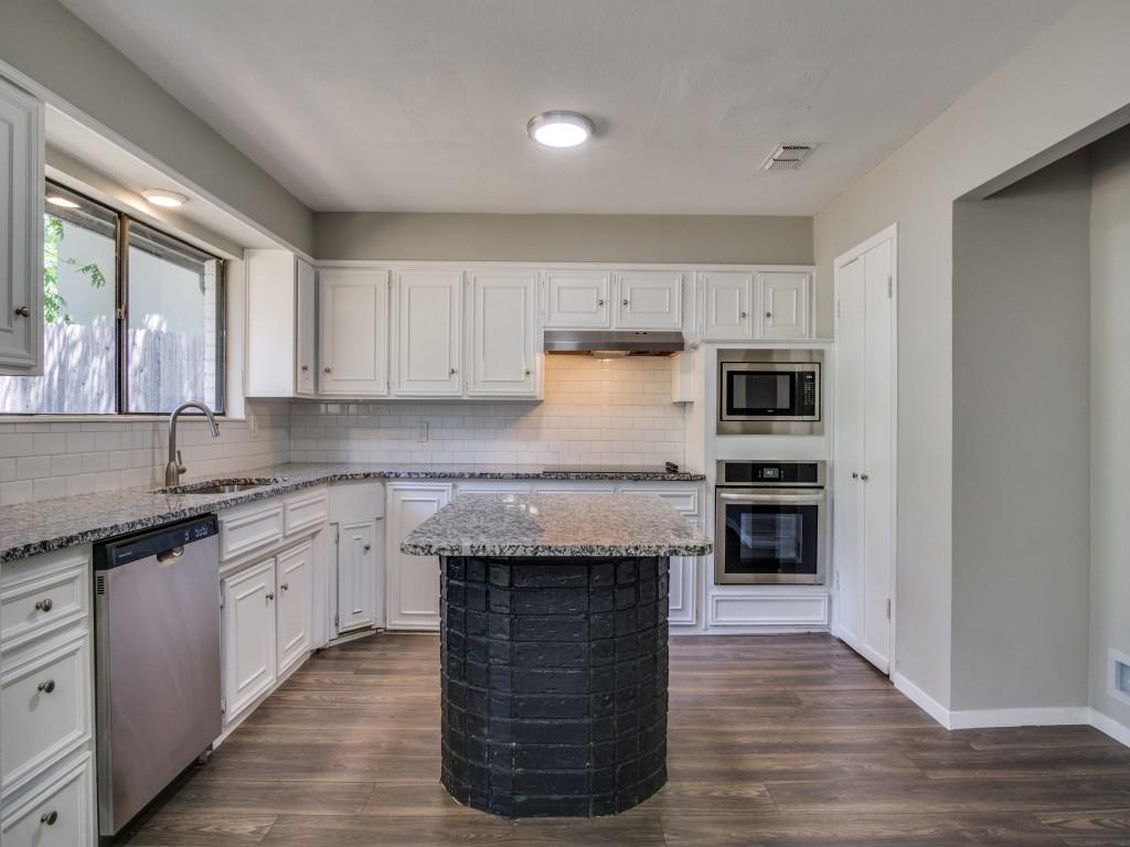 9523 Bellechase Road Granbury, TX 76049 - Photo 8 of 25 a kitchen with kitchen island granite countertop a stove sink and cabinets