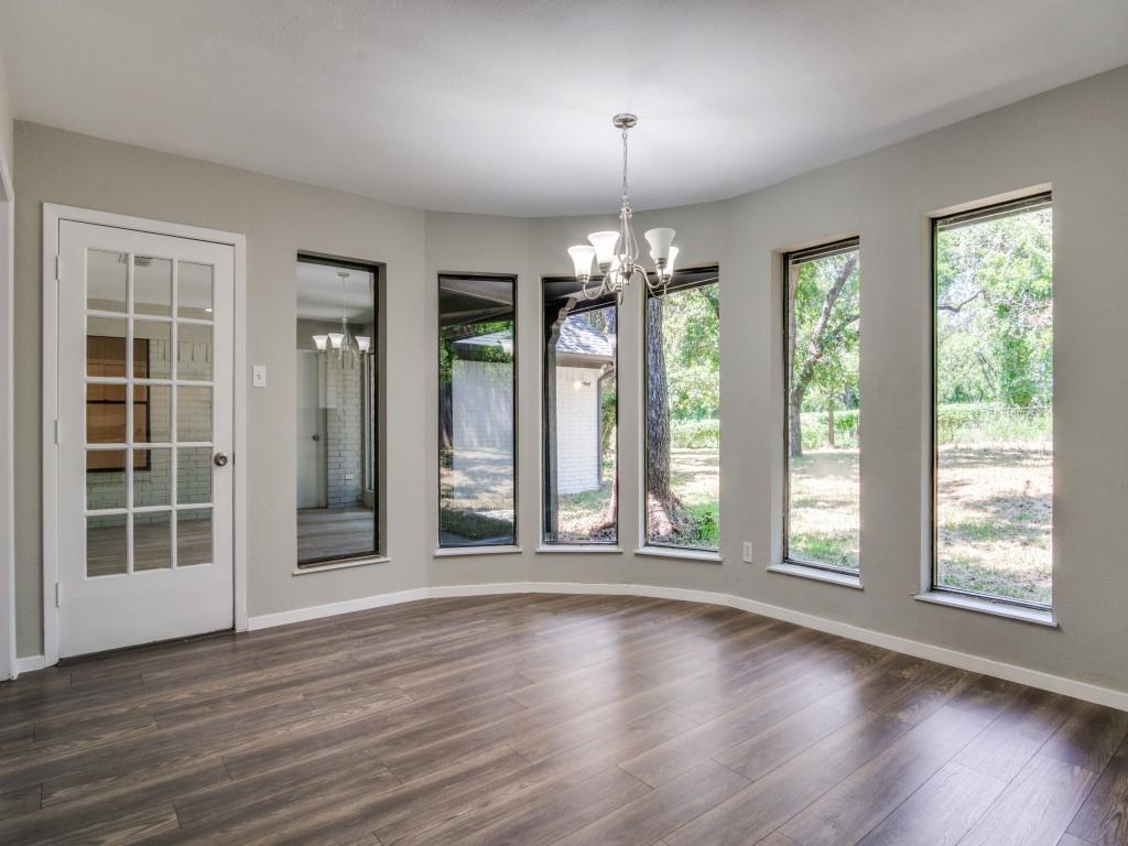 9523 Bellechase Road Granbury, TX 76049 - Photo 9 of 25 a view of an empty room with wooden floor and a window