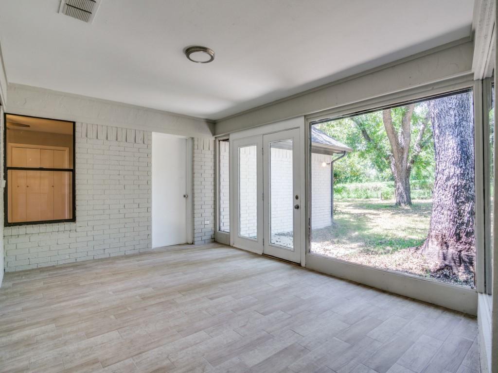 9523 Bellechase Road Granbury, TX 76049 - Photo 10 of 25 a view of an empty room with wooden floor and a window