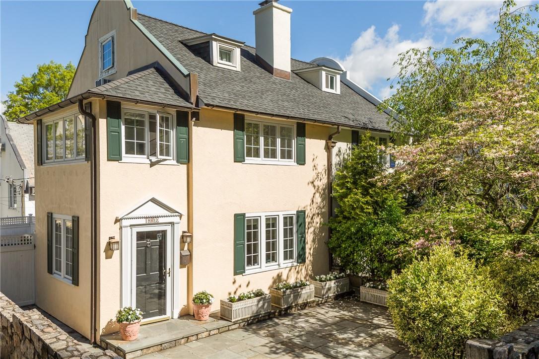 a front view of a house with a garden