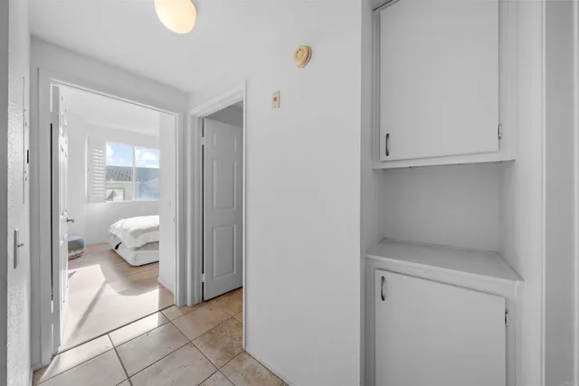 a view of a room with a window and ceiling fan