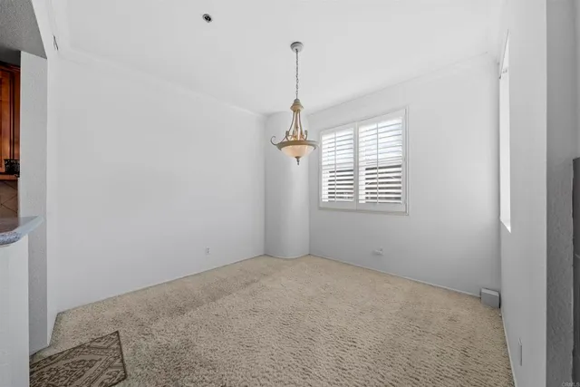 a living room with furniture a large window and a fireplace