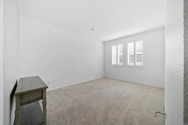 a bed room with a bed and a chair