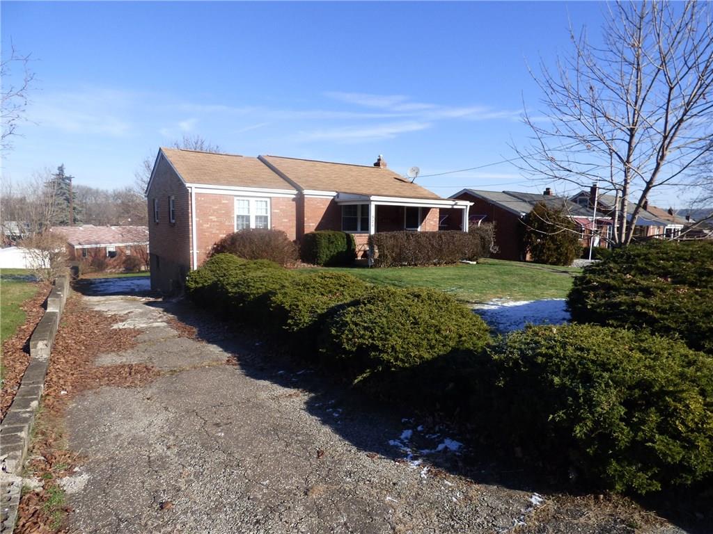 524 Scene Ridge Road Liberty, PA 15133 - Photo 1 of 23 Exterior front. Mature landscaping, paved driveway with large parking area in the rear, newer roof, covered front porch, level front yard