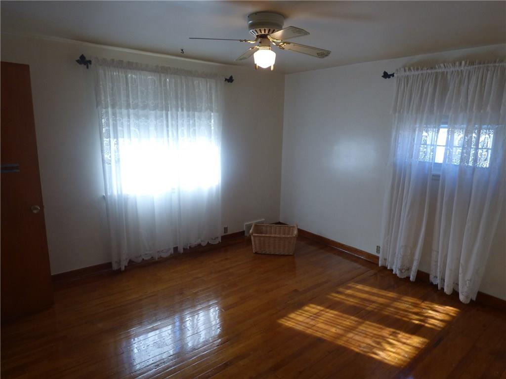 524 Scene Ridge Road Liberty, PA 15133 - Photo 2 of 23 Large bedroom with gleaming hardwood floors, large closet, new windows and Ceiling light/fan combo.