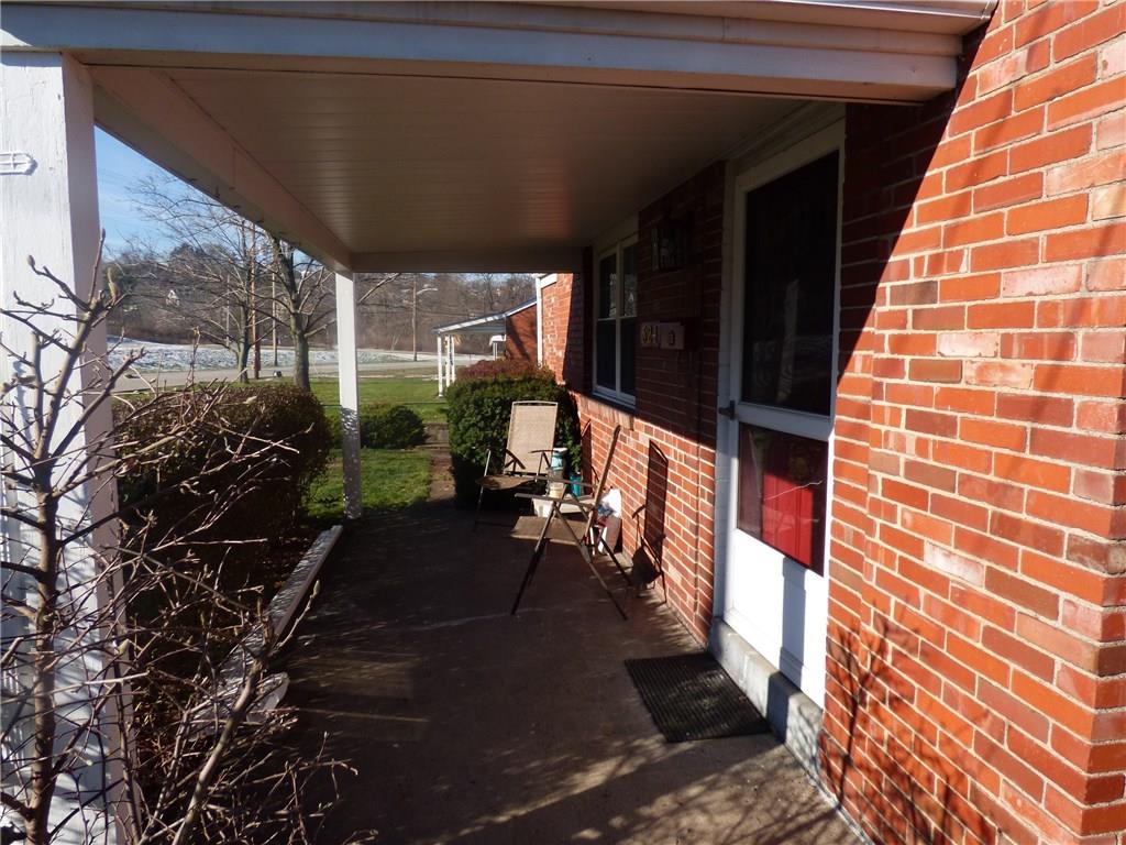524 Scene Ridge Road Liberty, PA 15133 - Photo 4 of 23 Covered concrete front porch with concrete walk, storm door to allow light into living room on nice days.