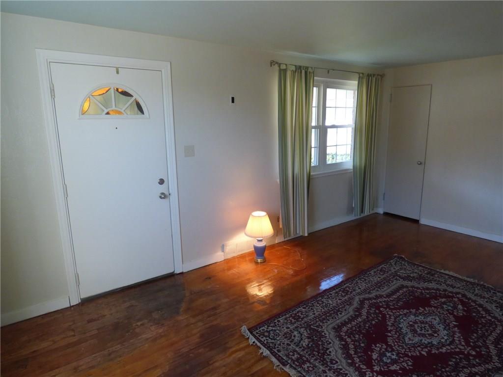 524 Scene Ridge Road Liberty, PA 15133 - Photo 6 of 23 Large living room includes hard wood floors, multiple newer windows, handy coat closet and door with fan light window at top