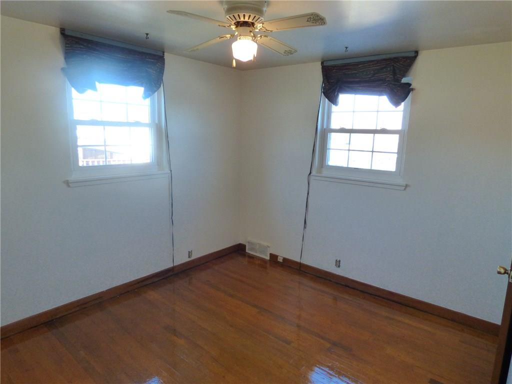 524 Scene Ridge Road Liberty, PA 15133 - Photo 10 of 23 Bedroom 2 is large with multiple windows, hard wood floors, large closet and ceiling fan/light combo.