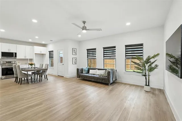 a living room with furniture and a wooden floor