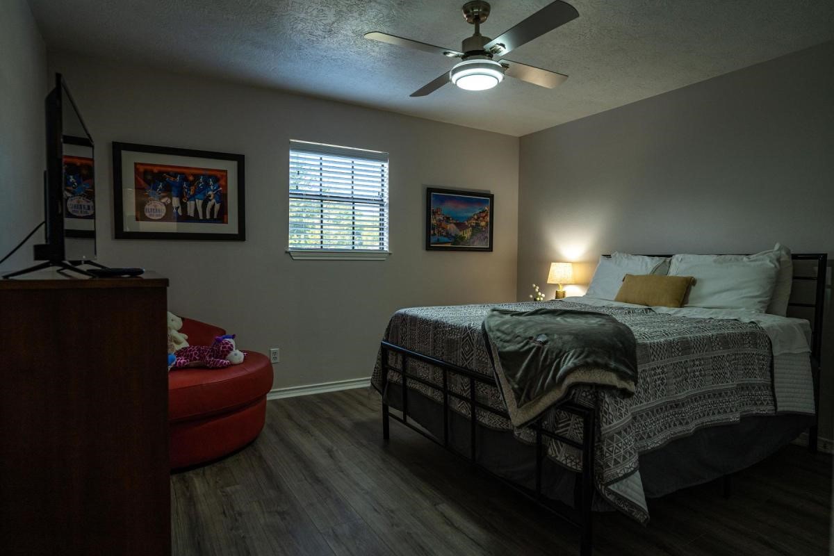 13209 Bluff View Drive Willis, TX 77318 - Photo 15 of 21 a bedroom with a bed and wooden floor