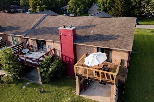 an aerial view of a house with swimming pool and garden