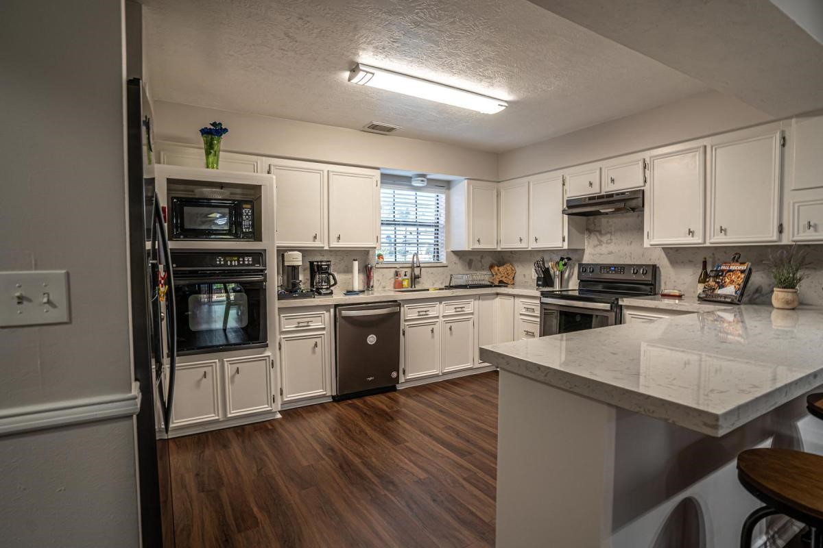 13209 Bluff View Drive Willis, TX 77318 - Photo 8 of 21 a kitchen with granite countertop a refrigerator stove top oven and sink