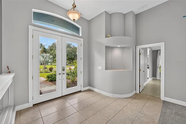 an empty room with windows and entrance