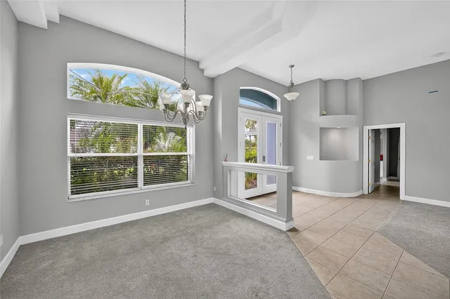 an empty room with windows and entrance