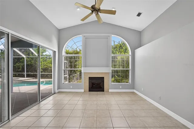 wooden floor fireplace and windows in an empty room