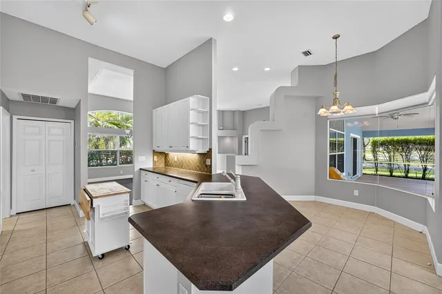 an empty room with large windows and a fireplace