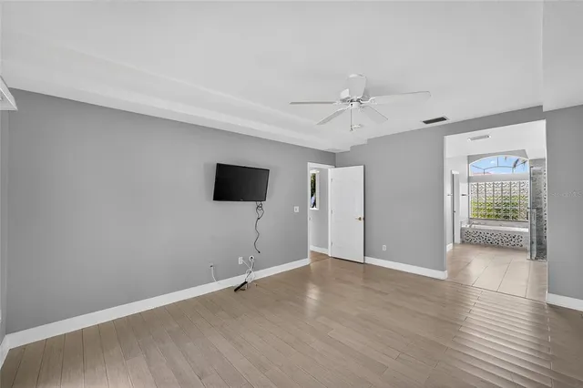 a large white kitchen with a large window and stainless steel appliances