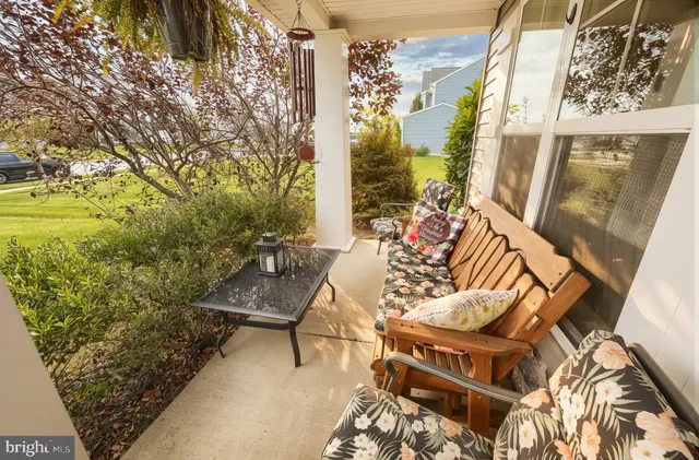 a living room with furniture wooden floor and a large window