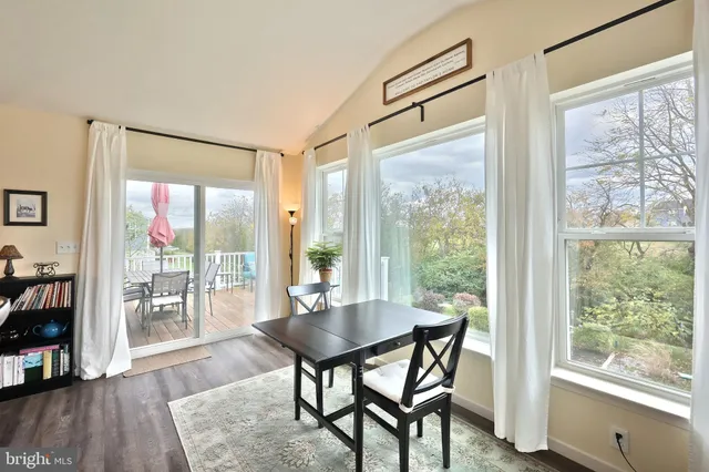a living room with furniture fireplace and a window