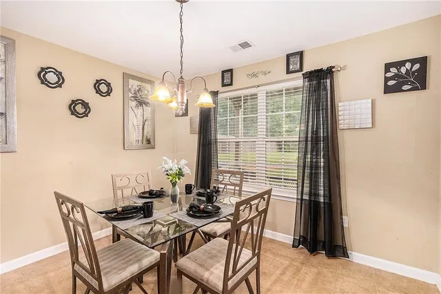 a view of a dining room with furniture and chandelier