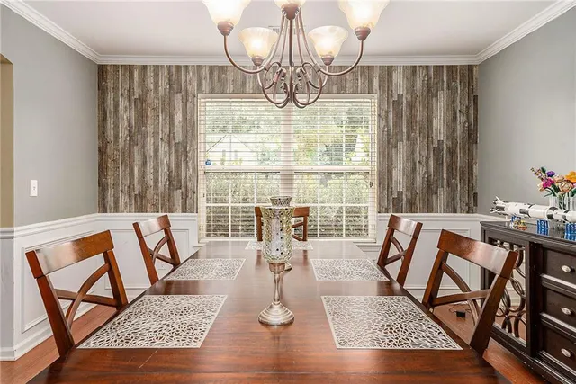 a view of a dining room with furniture wooden floor and chandelier