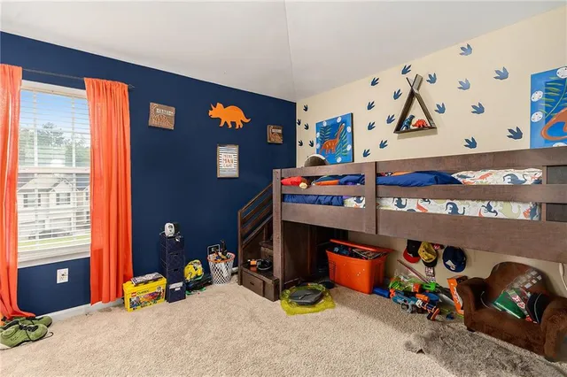 a bed room with a bed and a window