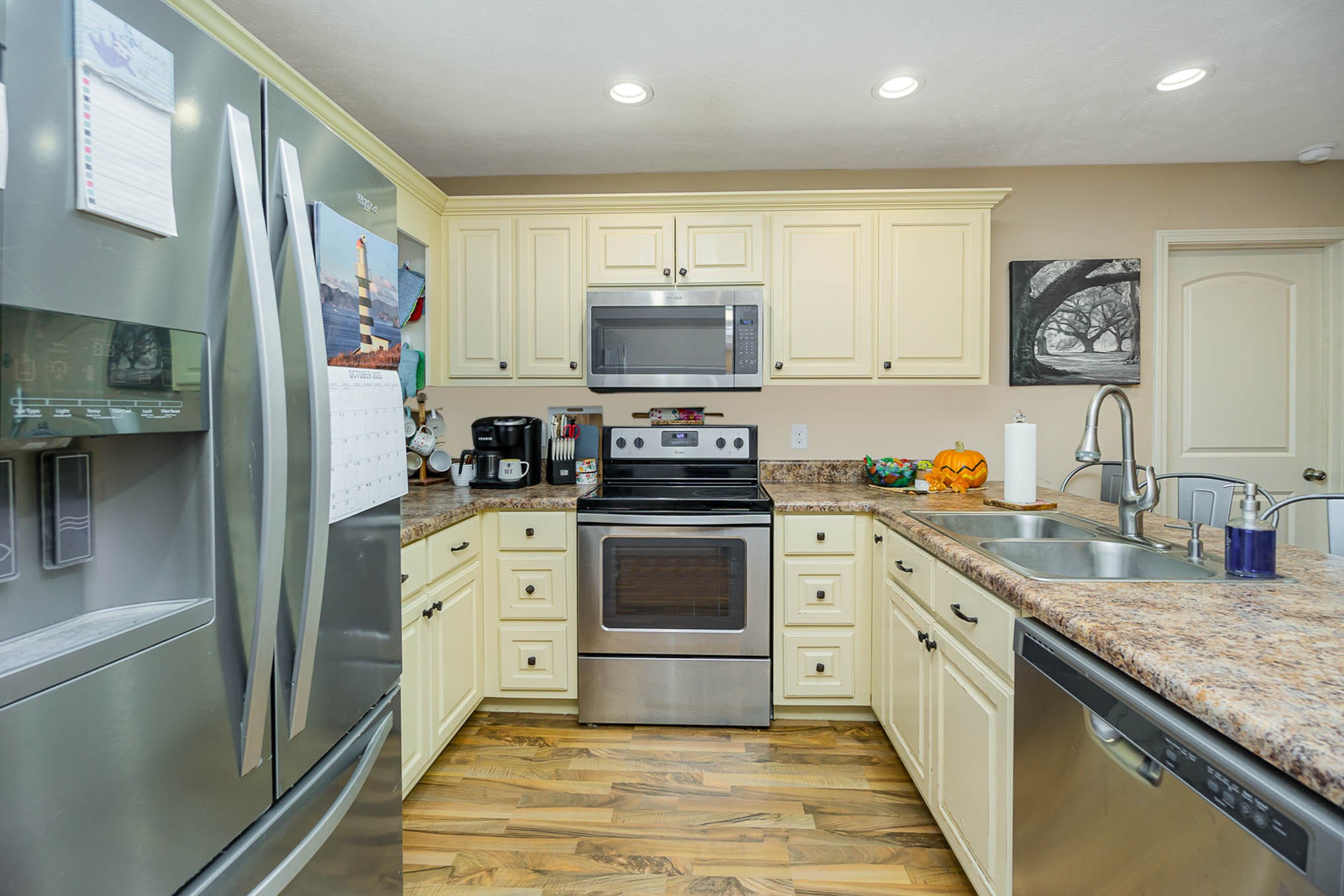 1679 Eno Road Dickson, TN 37055 - Photo 7 of 36 a kitchen with stainless steel appliances granite countertop a stove a sink and a refrigerator