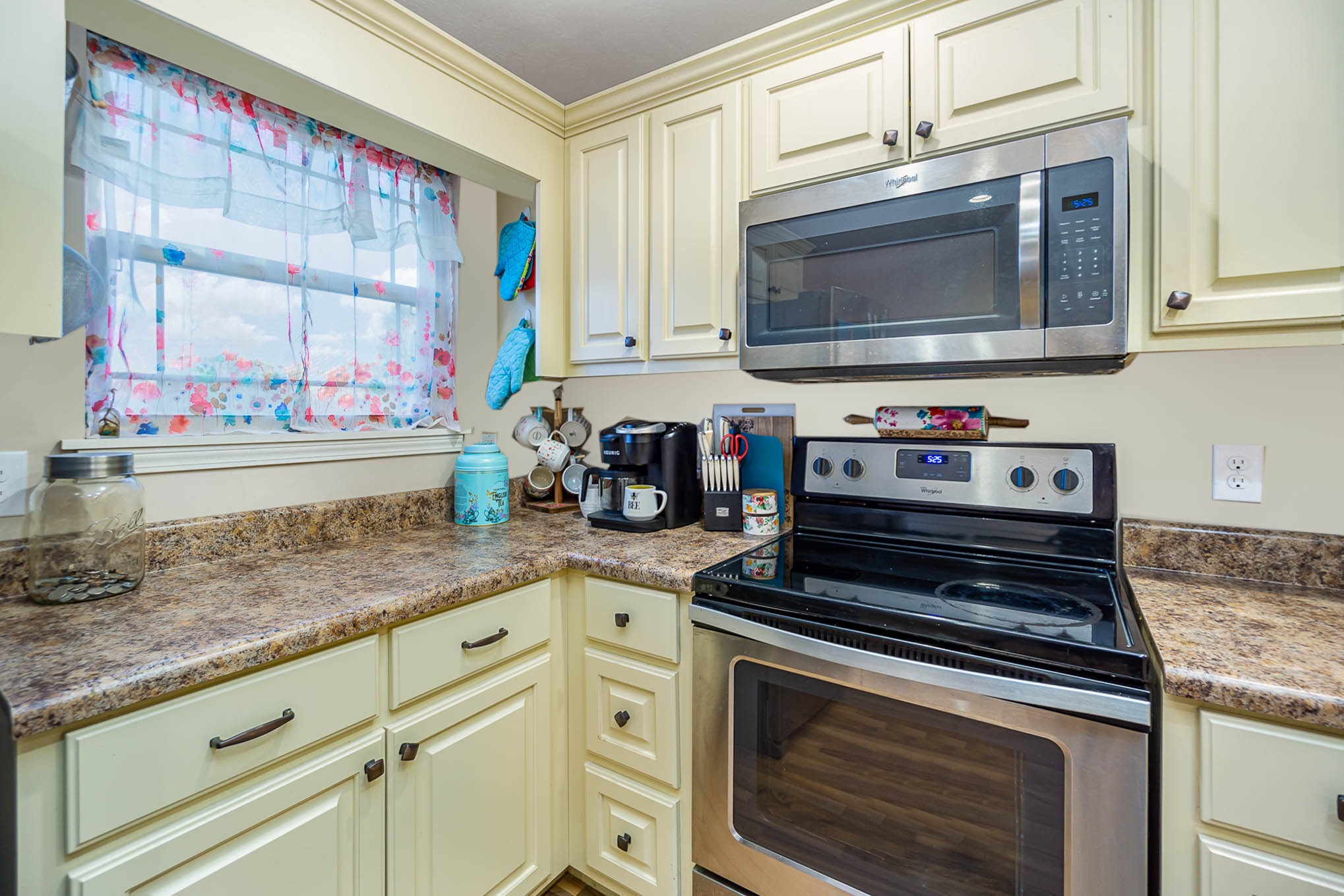 1679 Eno Road Dickson, TN 37055 - Photo 8 of 36 a kitchen with stainless steel appliances granite countertop a stove a microwave and a sink