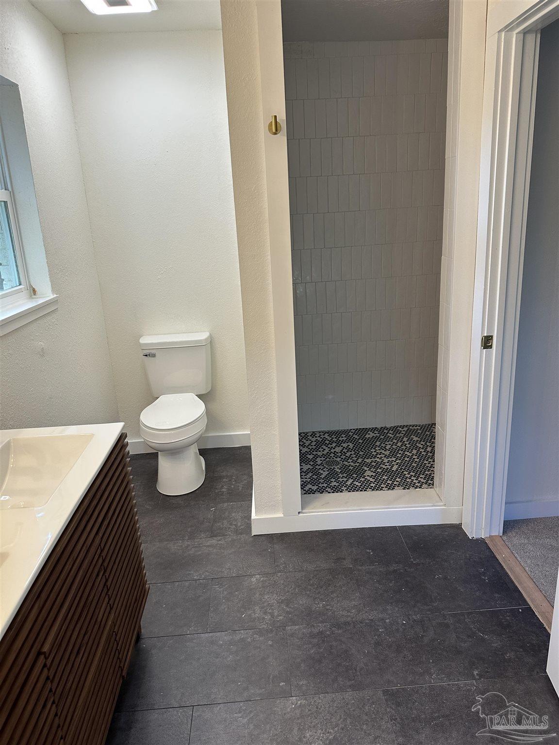 5520 Jones Street Milton, FL 32570 - Photo 14 of 16 a bathroom with a toilet and a shower