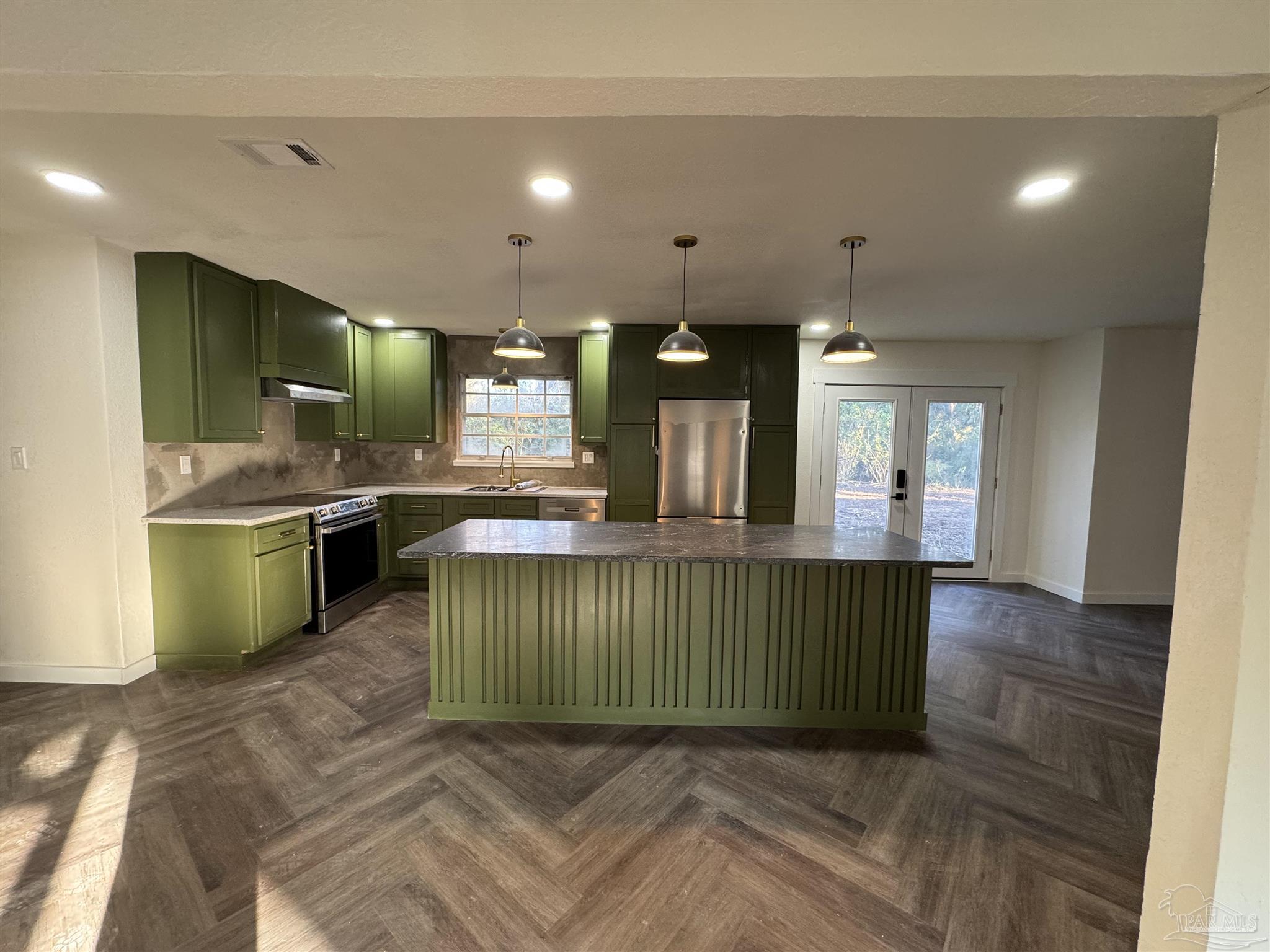 5520 Jones Street Milton, FL 32570 - Photo 3 of 16 a view of kitchen and hall with wooden floor