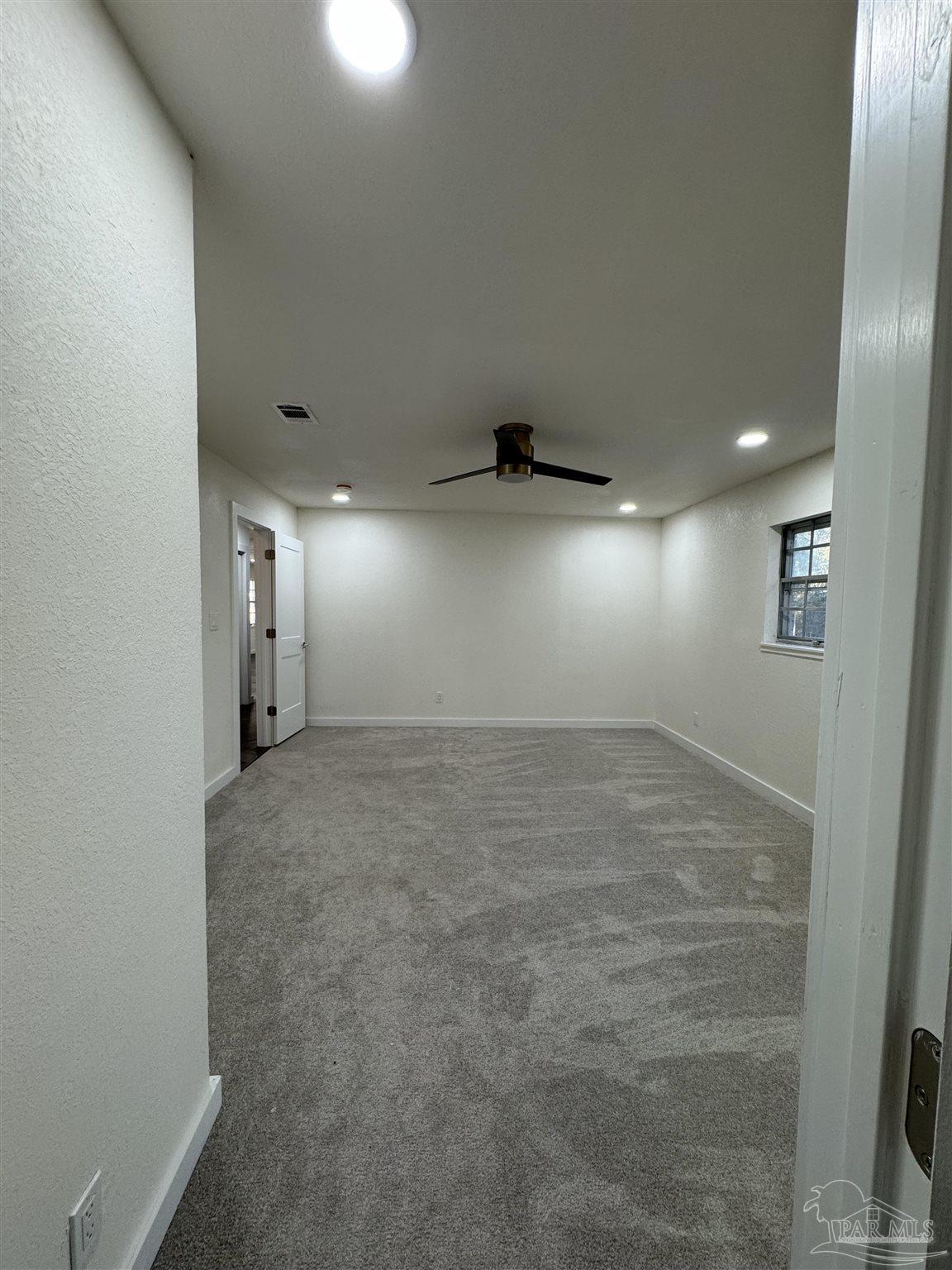 5520 Jones Street Milton, FL 32570 - Photo 7 of 16 an empty room with windows and entrance