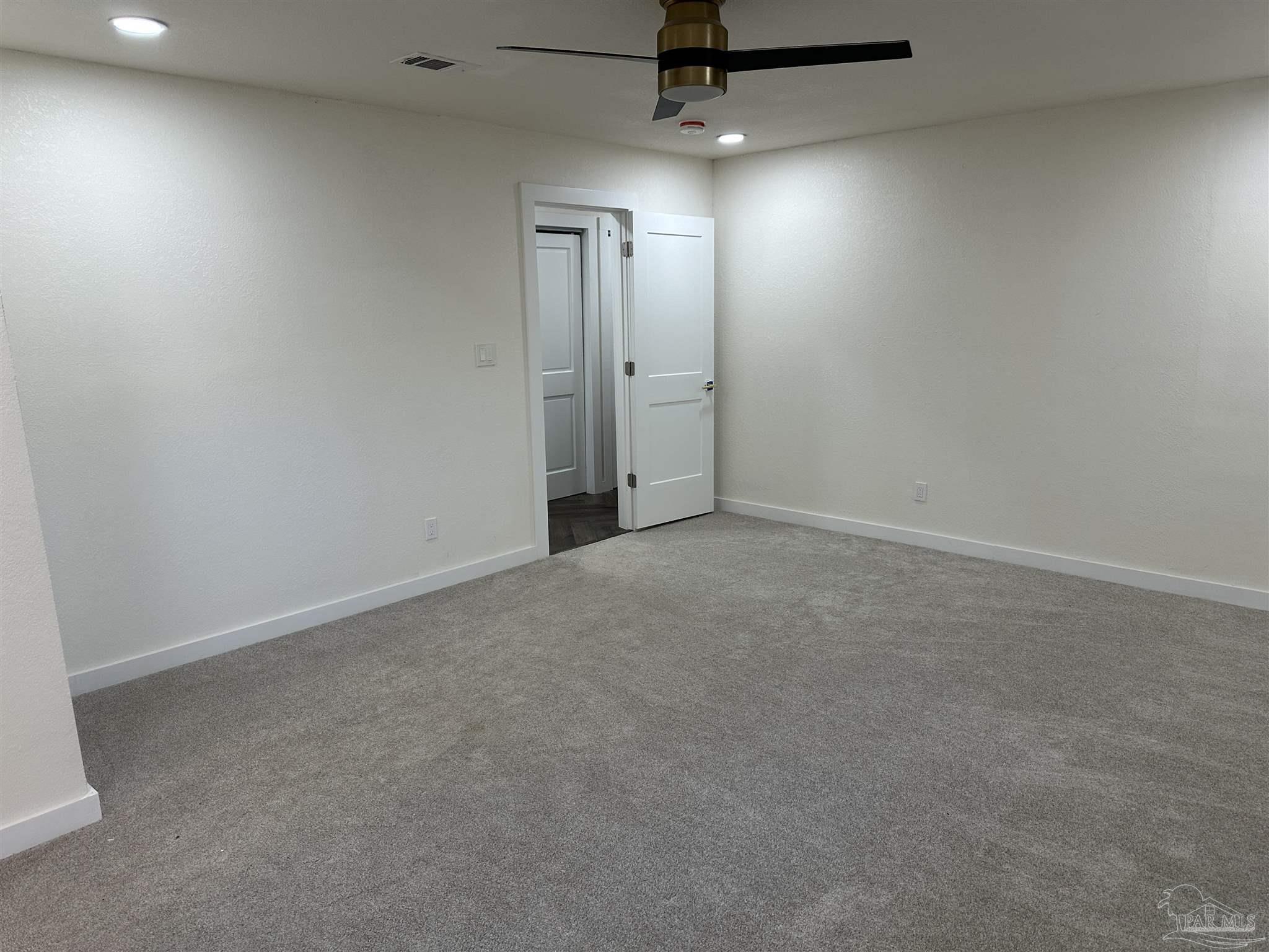 5520 Jones Street Milton, FL 32570 - Photo 8 of 16 an empty room with a fan & a window