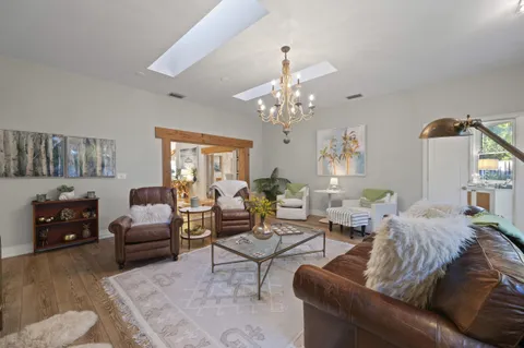 a living room with furniture fireplace and a large window