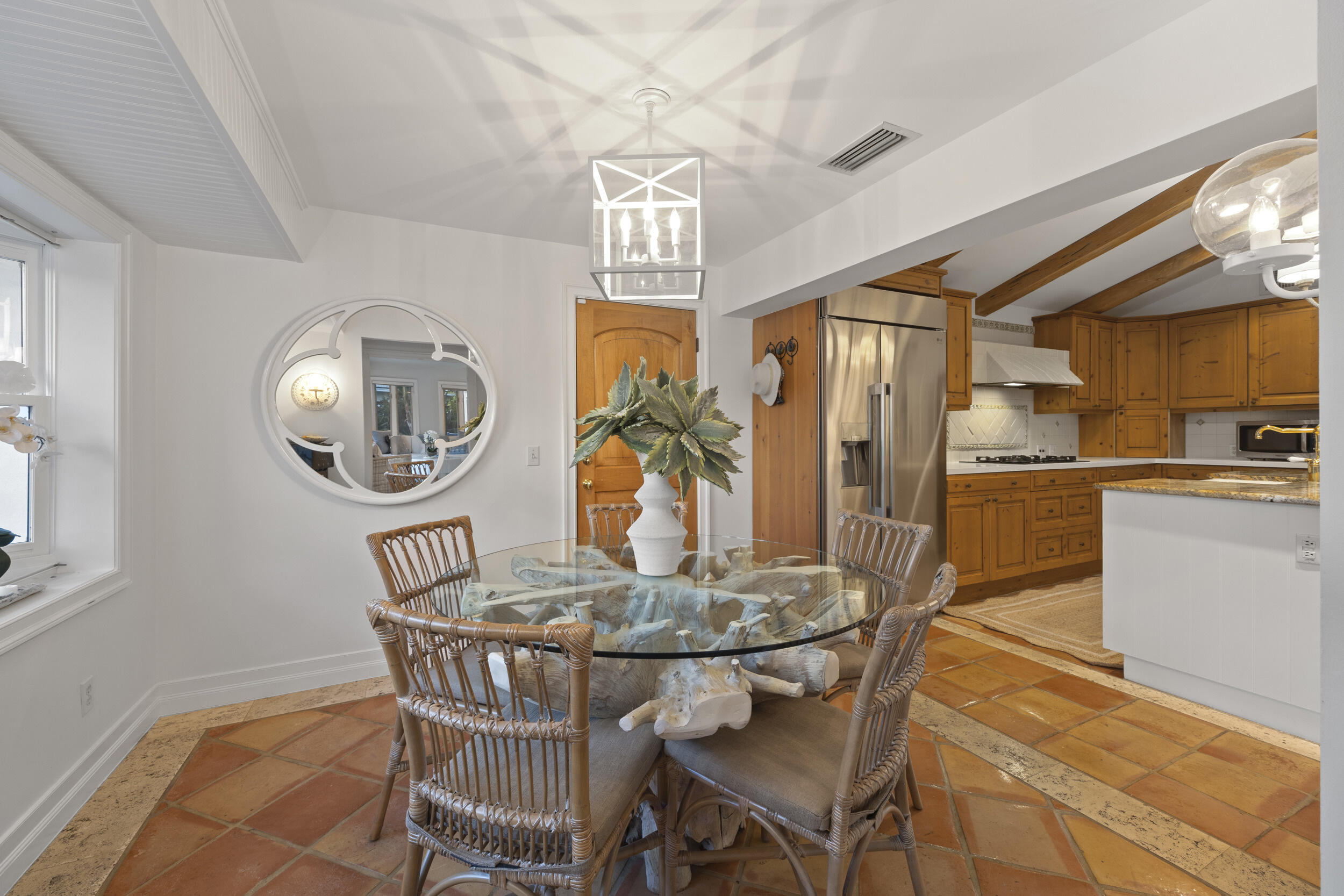 122 Lighthouse Drive Jupiter Inlet Colony, FL 33469 - Photo 20 of 84 a view of a dining room with furniture a chandelier and wooden floor