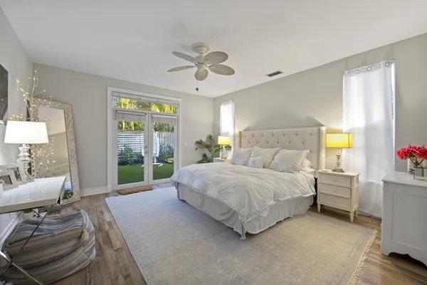 a spacious bedroom with a bed and ceiling fan