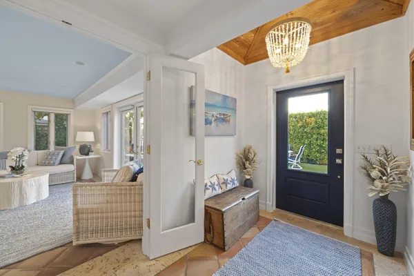 a living room with furniture a fireplace and a floor to ceiling window
