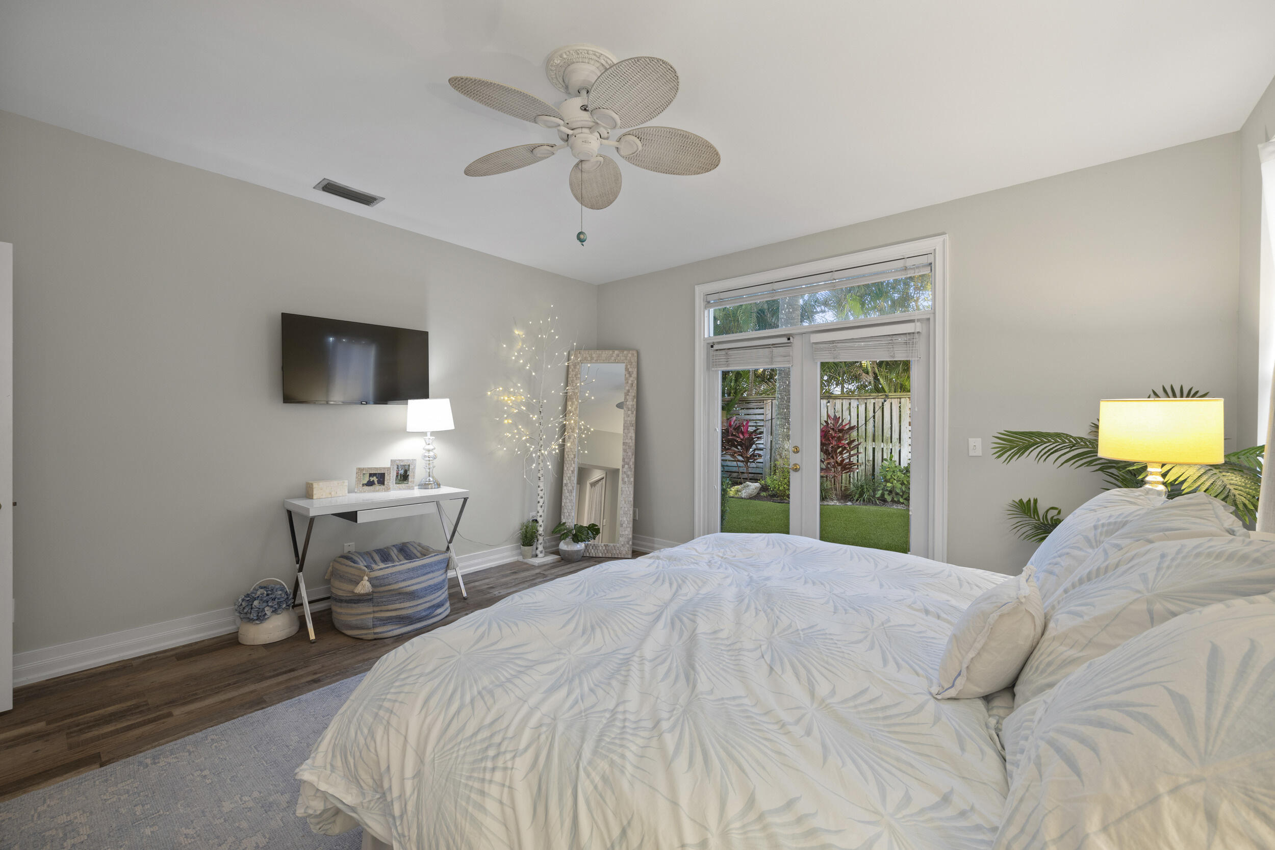 122 Lighthouse Drive Jupiter Inlet Colony, FL 33469 - Photo 32 of 84 a bedroom with a bed window and a flat screen tv